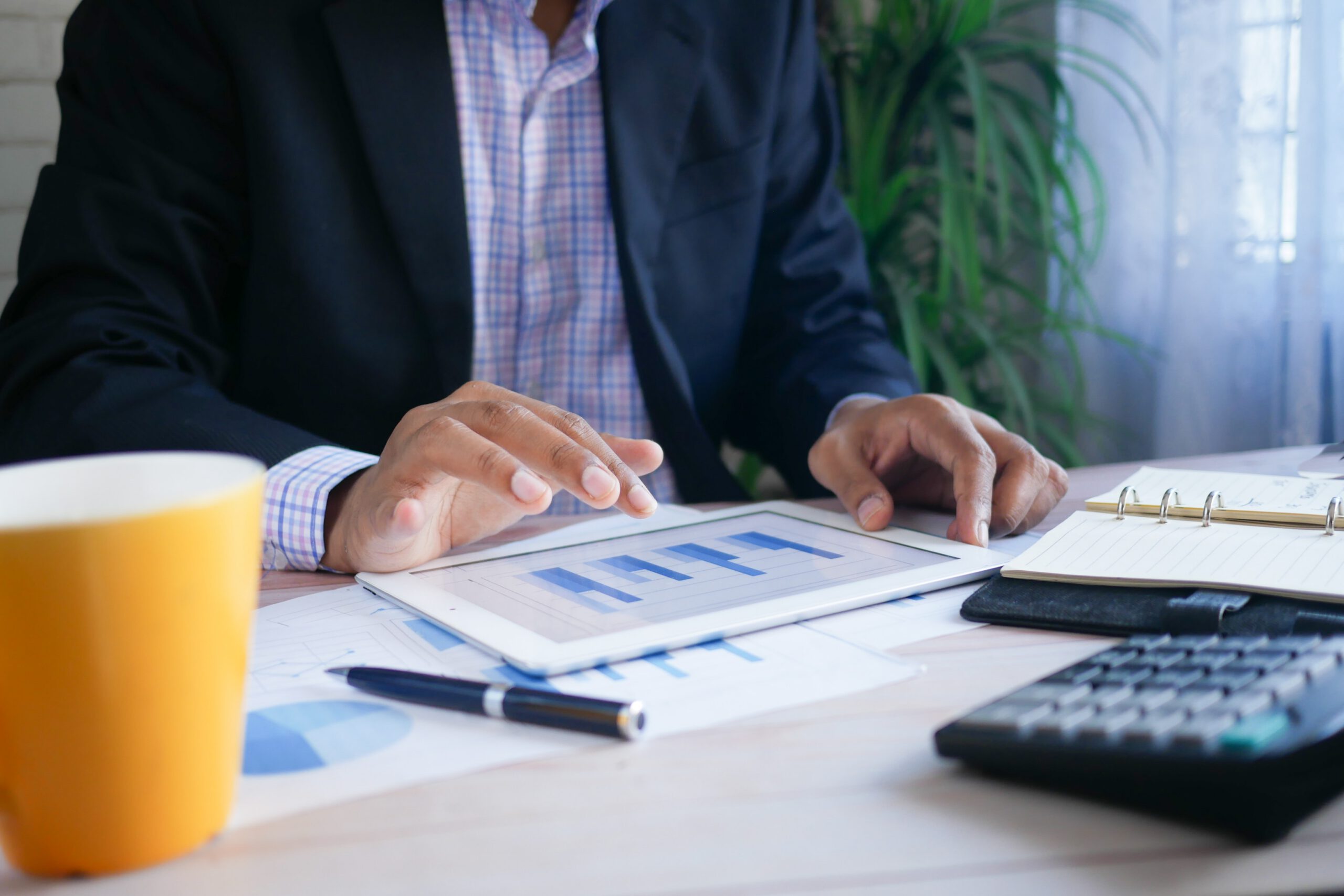 Businessman updating charts on iPad