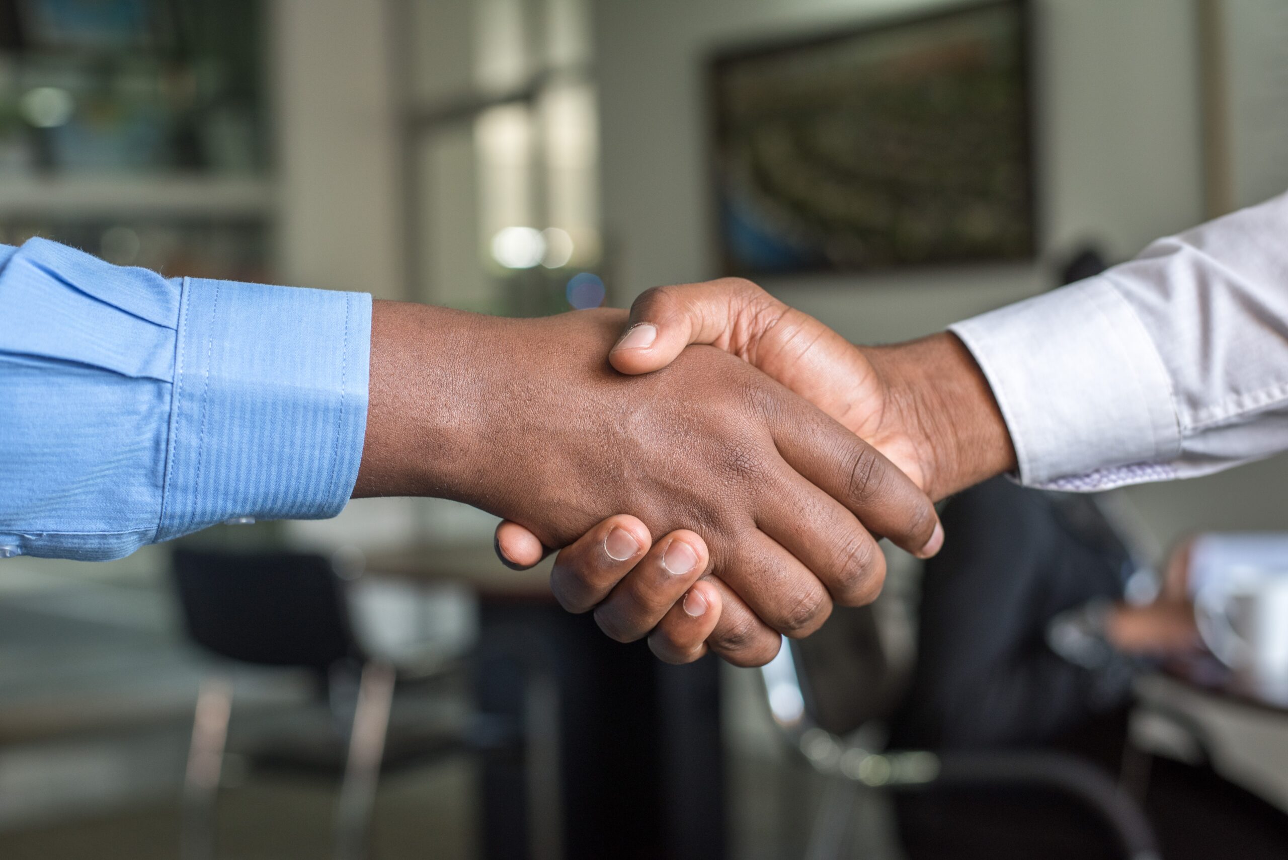 2 Businessmen shaking hands on a deal